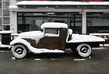 Image showing old rusty retro car covered with snow