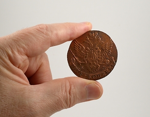 Image showing old Russian coin of the 18th century  hold between two fingers o