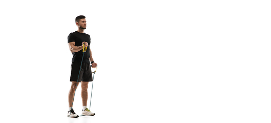Image showing Caucasian professional sportsman training isolated on white studio background. Muscular, sportive man practicing.