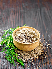 Image showing Cumin seeds in bowl with herbs on table