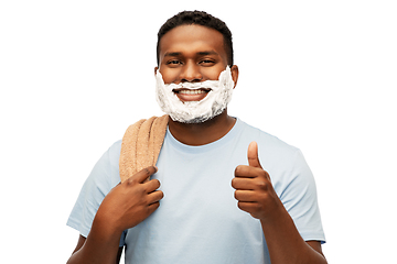 Image showing smiling african man with shaving foam and towel