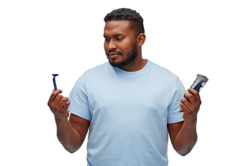 Image showing african man with razor blade and trimmer