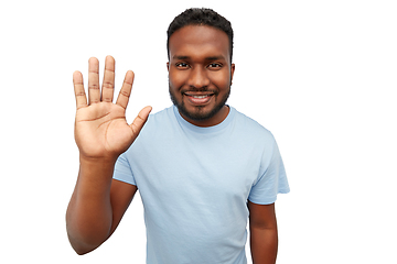 Image showing smiling african american young man waving hand