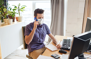 Image showing male office worker in mask calling on smarphone