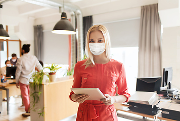 Image showing female office worker in mask with tablet pc