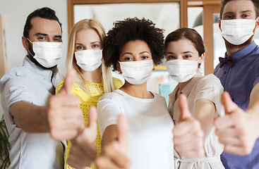 Image showing people in masks showing thumbs up at office