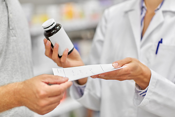 Image showing pharmacist and customer with medicine at pharmacy