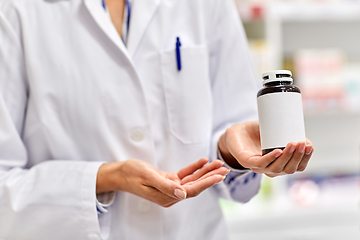 Image showing close up of pharmacist with medicine at pharmacy