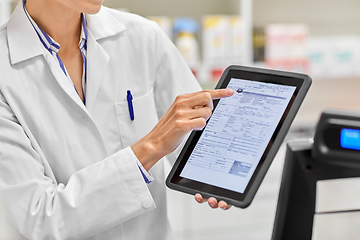 Image showing pharmacist with prescription on tablet pc