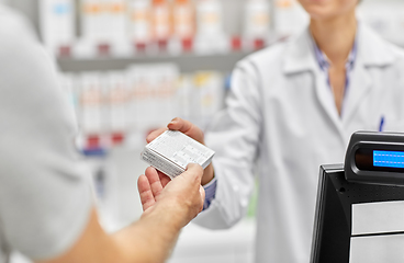 Image showing pharmacist and customer with medicine at pharmacy