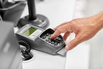 Image showing close up of hand with credit card in card-reader