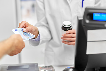 Image showing close up of pharmacist selling drug at pharmacy