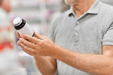 Image showing close up of customer choosing medicine at pharmacy