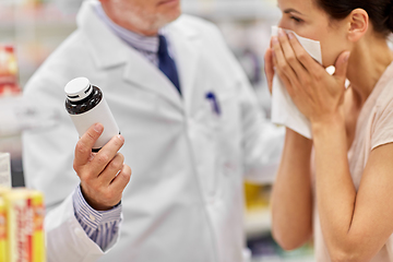 Image showing apothecary shows medicine to ill woman at pharmacy