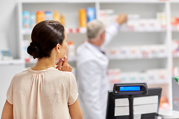 Image showing woman buying medicine at pharmacy