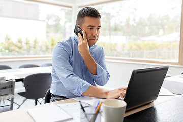 Image showing man calling on smartphone at home office