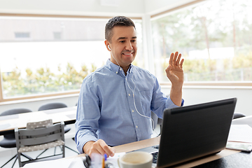 Image showing man with laptop having video call at home office