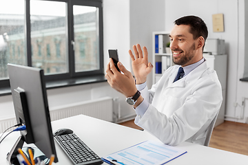 Image showing doctor with smartphone having video call at clinic