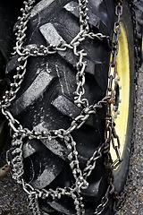 Image showing wheel chains on the wheel of the tractor   