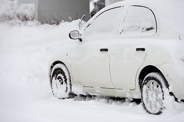 Image showing car covered with snow after snowfall 