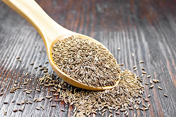 Image showing Cumin seeds in spoon on wooden table