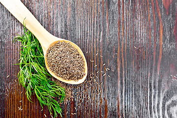 Image showing Cumin seeds in spoon with herbs on board top