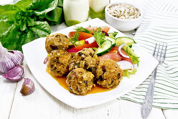 Image showing Meatballs with spinach and oatmeal on wooden table