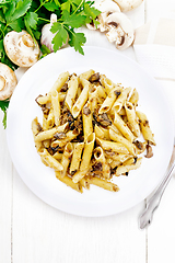 Image showing Pasta with mushrooms in white plate on light board top