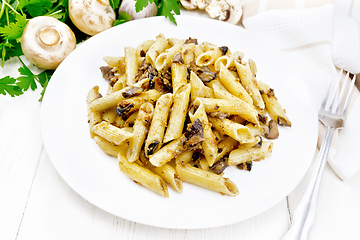 Image showing Pasta with mushrooms in white plate on wooden board