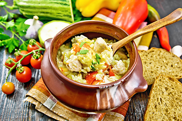 Image showing Rice with chicken and vegetables in pot on table