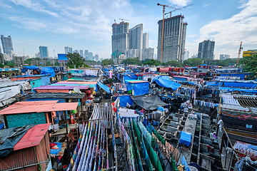 Image showing Dhobi Ghat is an open air laundromat lavoir in Mumbai, India with laundry drying on ropes