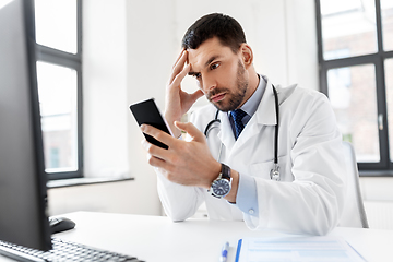 Image showing male doctor with smartphone at hospital