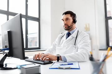 Image showing male doctor with computer and headset at hospital