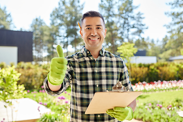 Image showing man with clipboard showing thumbs up at garden