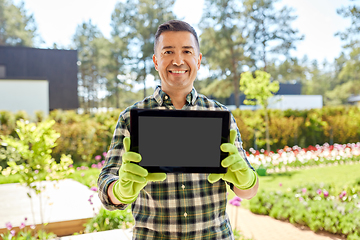 Image showing happy middle-aged man showing tablet pc at garden