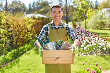 Image showing happy man with tools in box at summer garden