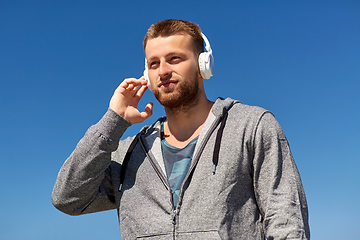 Image showing man in headphones listening to music outdoors