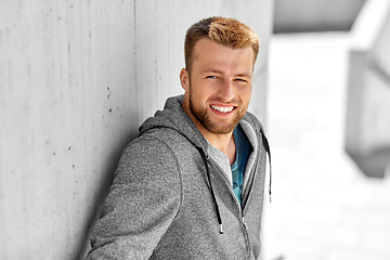 Image showing portrait of happy smiling young man outdoors