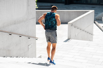 Image showing young man running downstairs