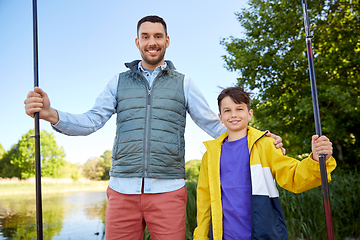 Image showing happy smiling father and son fishing on river