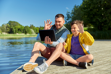 Image showing father and son with tablet pc having video call