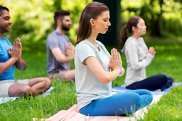 Image showing group of happy people doing yoga at summer park