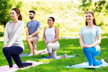 Image showing group of people doing yoga at summer park