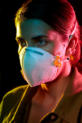 Image showing young woman wearing protective mask or respirator