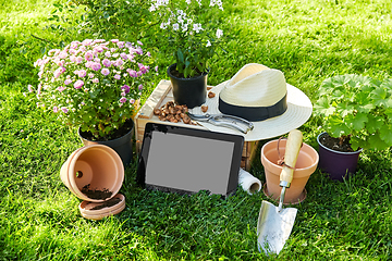 Image showing tablet pc, garden tools and flowers at summer