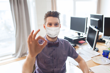 Image showing male office worker in mask showing ok sign