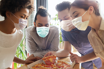 Image showing business team eating in masks pizza at office