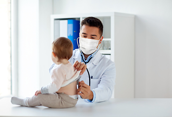 Image showing doctor in mask with stethoscope and baby at clinic