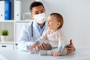 Image showing doctor or pediatrician in mask with baby at clinic