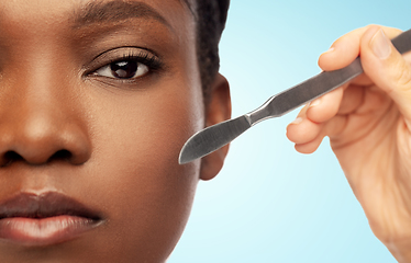 Image showing face of african american woman and scalpel knife